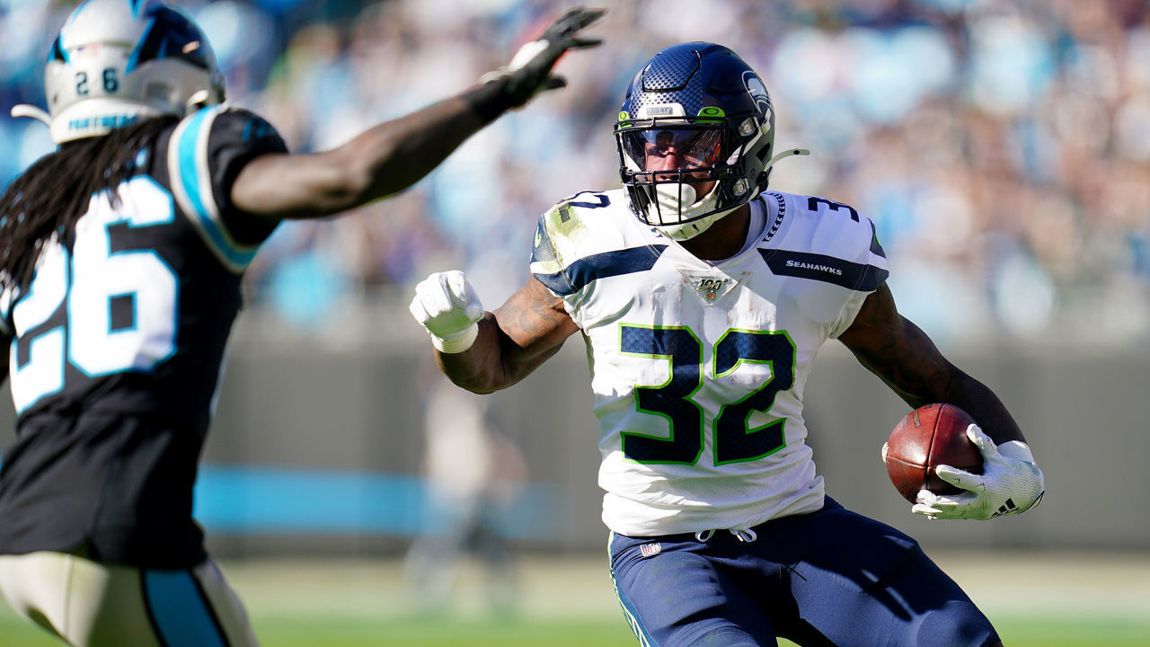 CHARLOTTE, NORTH CAROLINA - DECEMBER 15: Chris Carson #32 of the Seattle Seahawks runs with the ball during the first quarter during their game against the Carolina Panthers at Bank of America Stadium on December 15, 2019 in Charlotte, North Carolina.