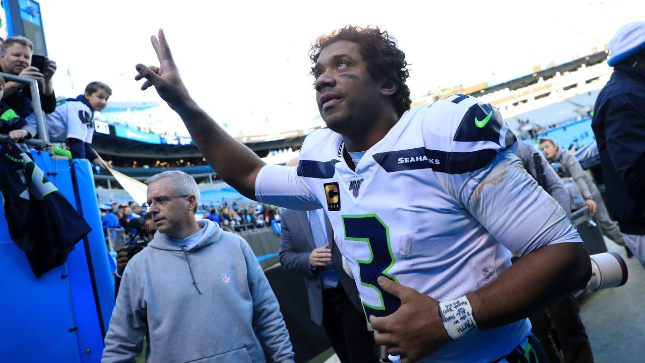 CHARLOTTE, NORTH CAROLINA - DECEMBER 15: Russell Wilson #3 of the Seattle Seahawks watches on after defeating the Carolina Panthers 30-24 at Bank of America Stadium on December 15, 2019 in Charlotte, North Carolina.
