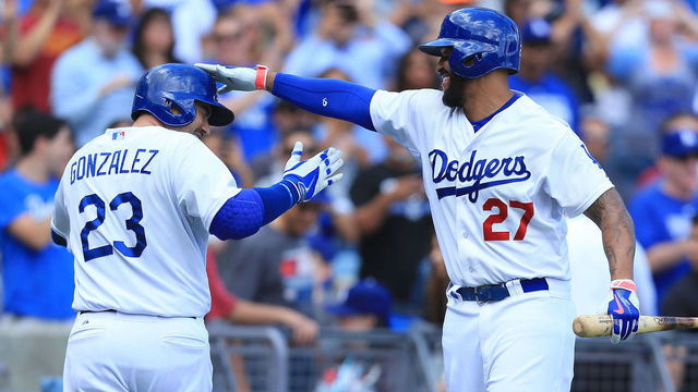 LOS ANGELES, CA - SEPTEMBER 28: Matt Kemp #27 of the Los Angeles Dodgers congratulates teammate Adrian Gonzalez #23 after Gonzalez hit a three-run home run in the third inning during the MLB game against the Colorado Rockies at Dodger Stadium on September 28, 2014 in Los Angeles, California.