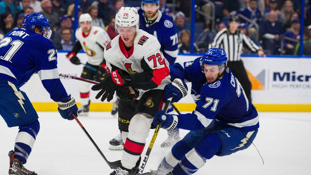 TAMPA, FL - DECEMBER 17: Anthony Cirelli #71 of the Tampa Bay Lightning steals the puck from Thomas Chabot #72 of the Ottawa Senators during overtime at Amalie Arena on December 17, 2019 in Tampa, FL