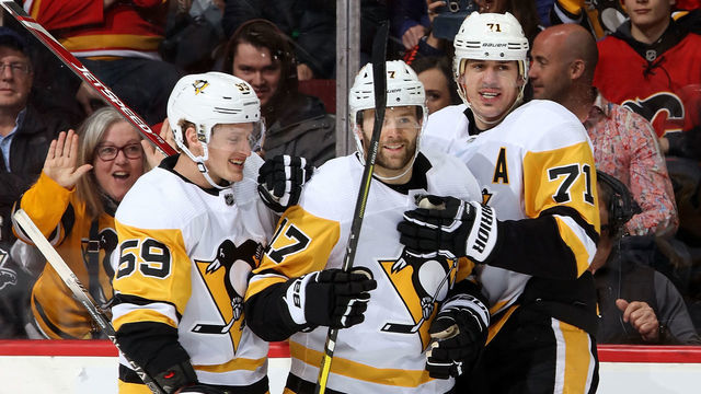 CALGARY, AB - DECEMBER 17: Bryan Rust #17, Jake Guentzel #59 and Evgeni Malkin #71 of the Pittsburgh Penguins celebrate a goal against the Calgary Flames during an NHL game on December 17, 2019 at the Scotiabank Saddledome in Calgary, Alberta, Canada.