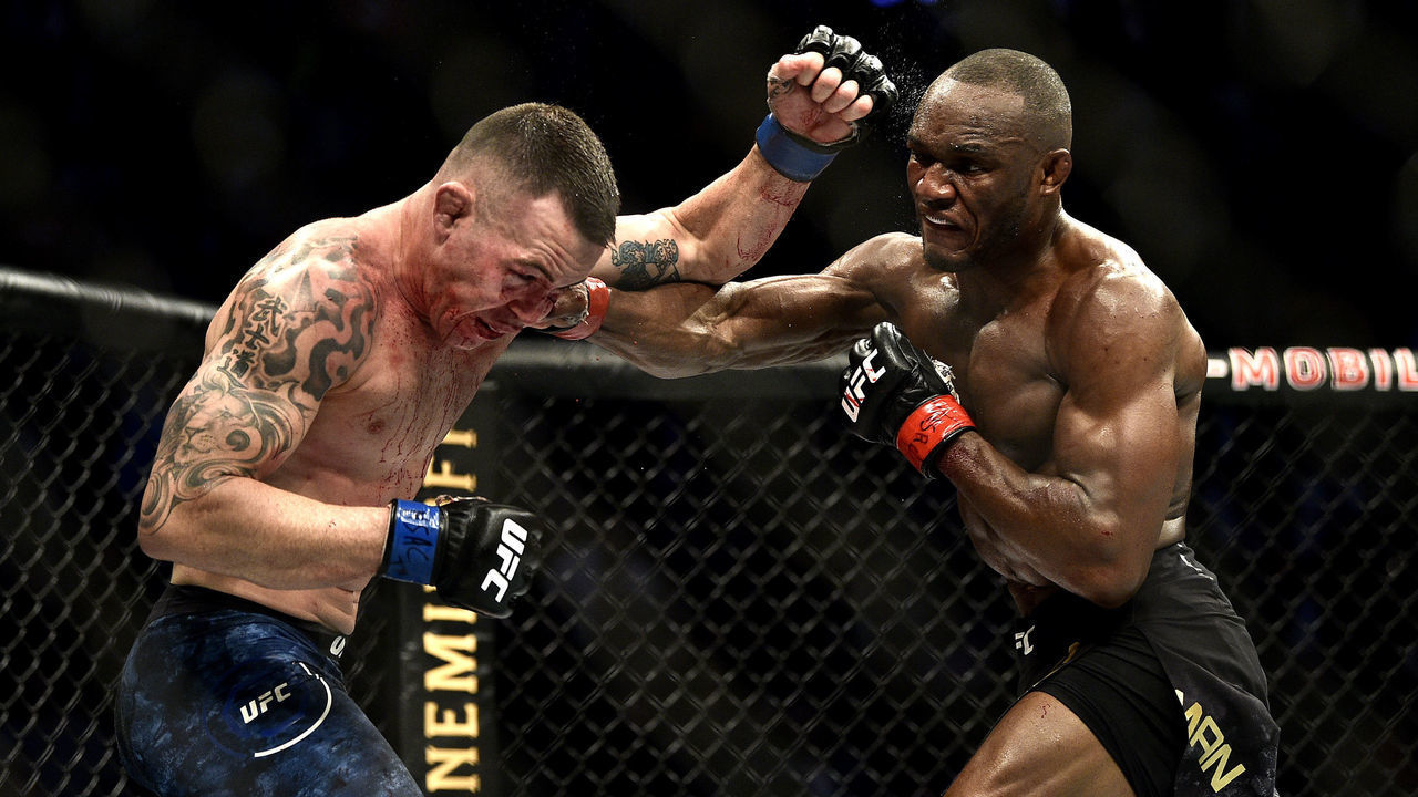 LAS VEGAS, NEVADA - DECEMBER 14: (L-R) Kamaru Usman of Nigeria punches Colby Covington in their UFC welterweight championship bout during the UFC 245 event at T-Mobile Arena on December 14, 2019 in Las Vegas, Nevada.