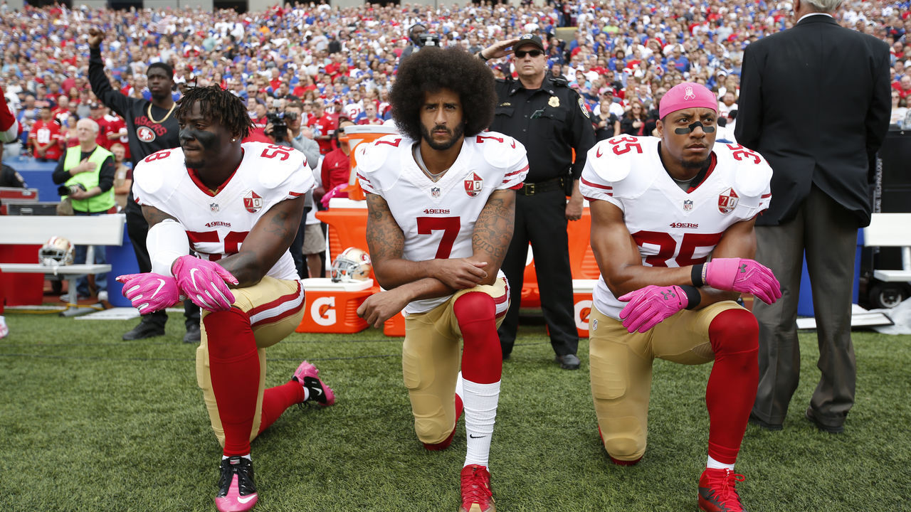 ORCHARD PARK, NY - OCTOBER 15: Eli Harold #58, Colin Kaepernick #7 and Eric Reid #35 of the San Francisco 49ers kneel in protest on the sideline, during the anthem, prior to the game against the Buffalo Bills at New Era Field on October 16, 2016 in Orchard Park, New York. The Bills defeated the 49ers 45-16.