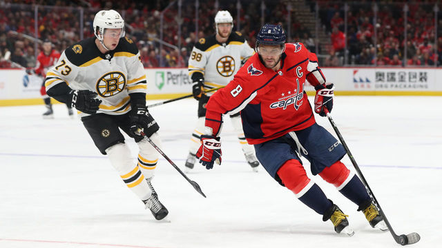 WASHINGTON, DC - DECEMBER 11: Alex Ovechkin #8 of the Washington Capitals skates with the puck past Charlie McAvoy #73 of the Boston Bruins during the second period at Capital One Arena on December 11, 2019 in Washington, DC.