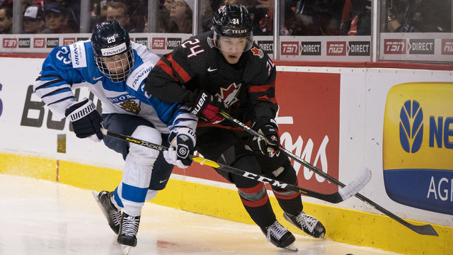 VANCOUVER, BC - JANUARY 2: Anton Lundell #29 of Finland tries to check Ty Smith #24 of Canada off the puck in Quarterfinal hockey action of the 2019 IIHF World Junior Championship on January, 2, 2019 at Rogers Arena in Vancouver, British Columbia, Canada.