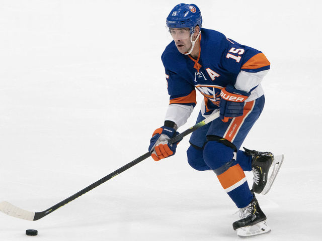 UNIONDALE, NY - DECEMBER 17: New York Islanders Right Wing Cal Clutterbuck (15) skates with the puck during the first period of the National Hockey League game between the Nashville Predators and the New York Islanders on December 17, 2019, at the Nassau Veterans Memorial Coliseum in Uniondale, NY.