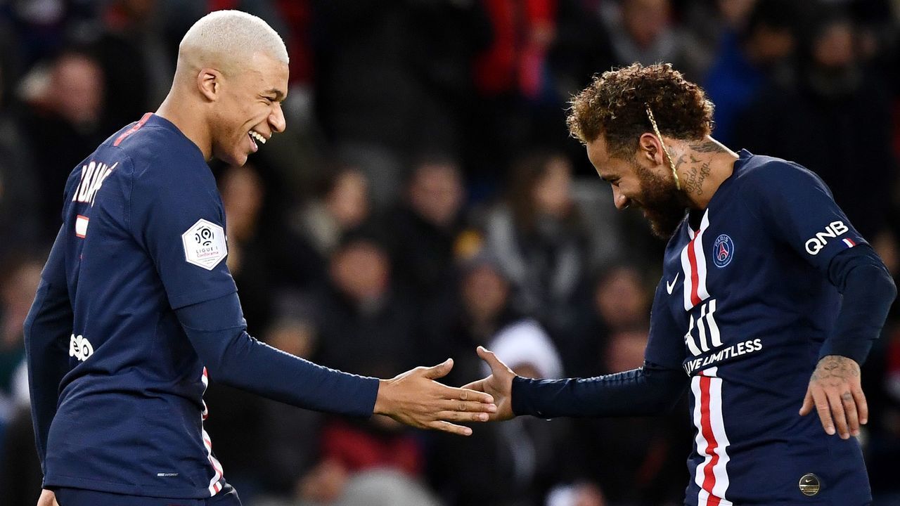 Paris Saint-Germain's French forward Kylian Mbappe (L) is congratuled by Paris Saint-Germain's Brazilian forward Neymar after scoring a goal during the French L1 football match between Paris Saint-Germain (PSG) and Amiens at the Parc des Princes stadium in Paris on December 21, 2019.