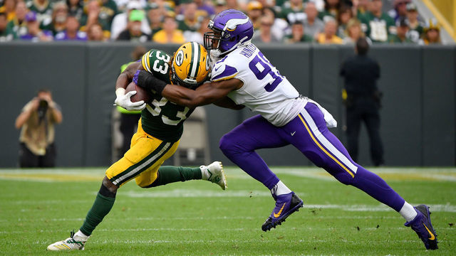 GREEN BAY, WISCONSIN - SEPTEMBER 15: Danielle Hunter #99 of the Minnesota Vikings tackles Aaron Jones #33 of the Green Bay Packers at Lambeau Field on September 15, 2019 in Green Bay, Wisconsin.