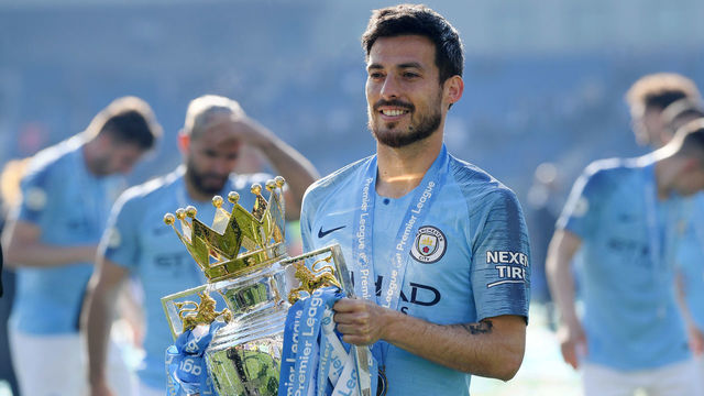 BRIGHTON, ENGLAND - MAY 12: David Silva of Manchester City celebrates with the Premier League Trophy after winning the title following the Premier League match between Brighton & Hove Albion and Manchester City at American Express Community Stadium on May 12, 2019 in Brighton, United Kingdom.