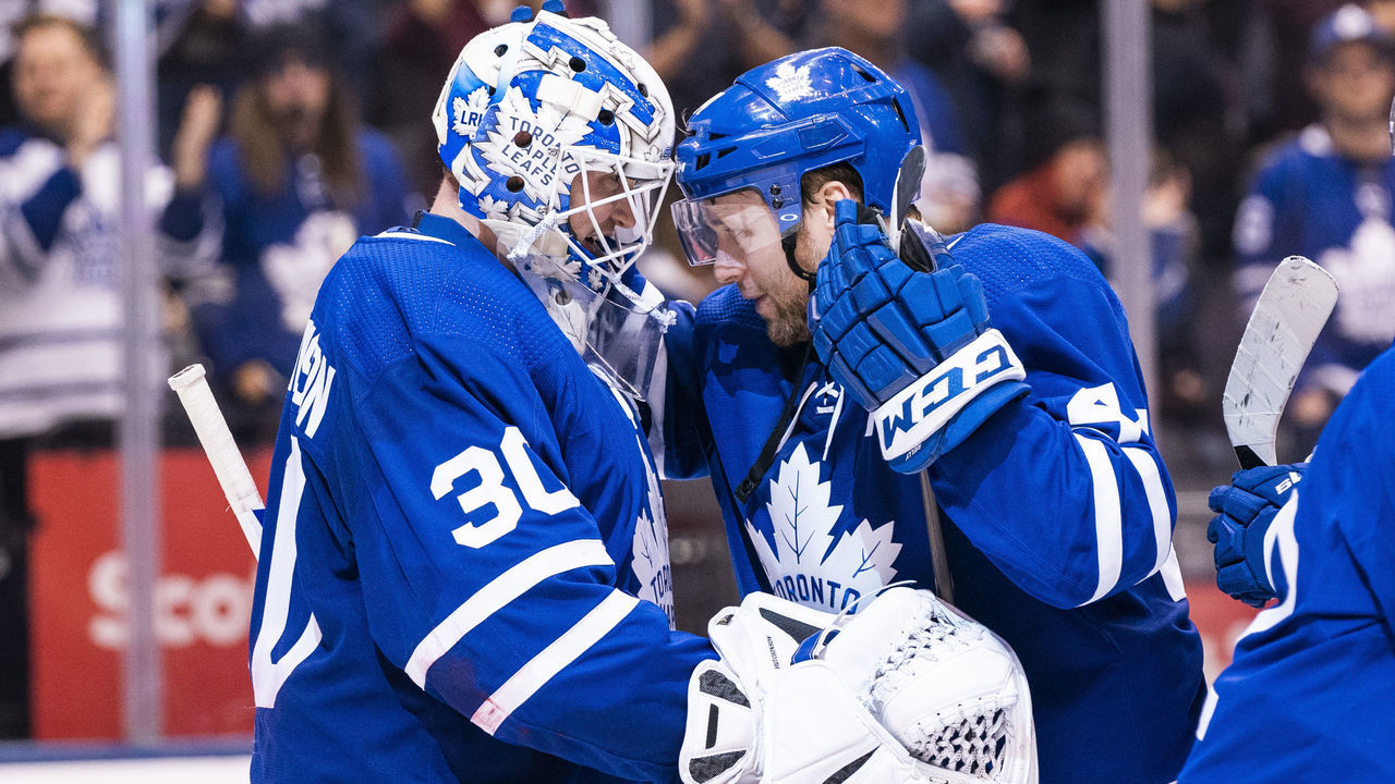 TORONTO, ON - DECEMBER 21: Michael Hutchinson #30 of the Toronto Maple Leafs celebrates with teammate Morgan Rielly #44 after defeating the Detroit Red Wings at the Scotiabank Arena on December 21, 2019 in Toronto, Ontario, Canada.