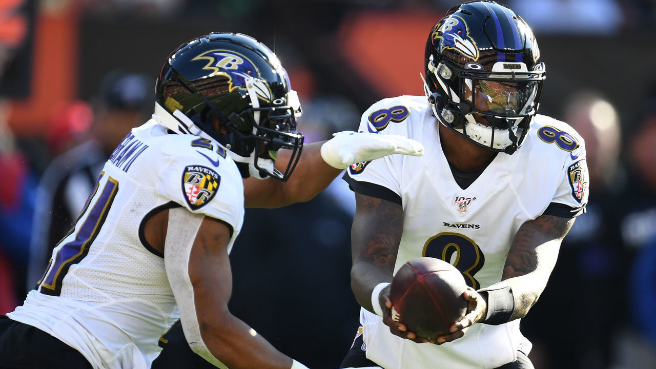 CLEVELAND, OHIO - DECEMBER 22: Lamar Jackson #8 of the Baltimore Ravens hands the ball off to Mark Ingram #21 against the Cleveland Browns during the first half in the game at FirstEnergy Stadium on December 22, 2019 in Cleveland, Ohio.