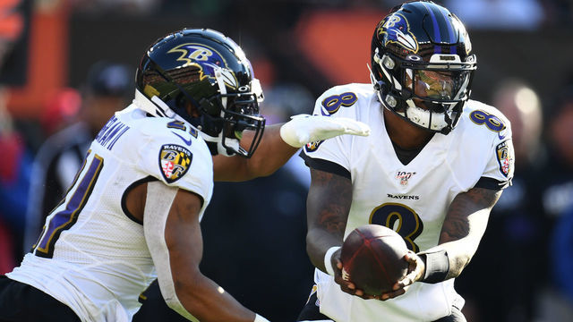CLEVELAND, OHIO - DECEMBER 22: Lamar Jackson #8 of the Baltimore Ravens hands the ball off to Mark Ingram #21 against the Cleveland Browns during the first half in the game at FirstEnergy Stadium on December 22, 2019 in Cleveland, Ohio.