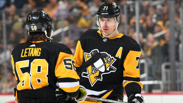 PITTSBURGH, PA - APRIL 04: Evgeni Malkin #71 talks with Kris Letang #58 of the Pittsburgh Penguins during the game against the Detroit Red Wings at PPG Paints Arena on April 4, 2019 in Pittsburgh, Pennsylvania.