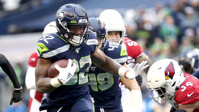 SEATTLE, WASHINGTON - DECEMBER 22: Running back Chris Carson #32 of the Seattle Seahawks carries the ball against the defense of strong safety Jalen Thompson #34 of the Arizona Cardinals during the game at CenturyLink Field on December 22, 2019 in Seattle, Washington.