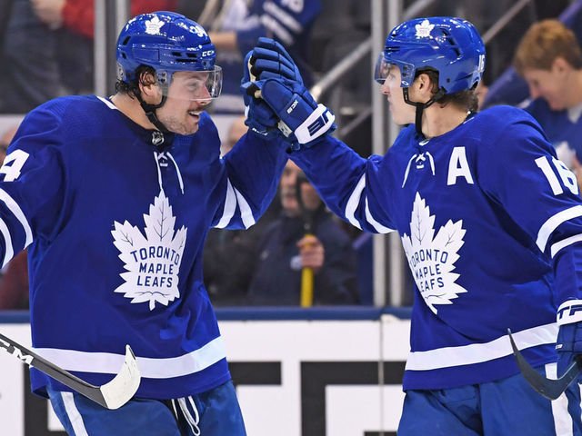TORONTO, ON - DECEMBER 23: Toronto Maple Leafs Right Wing Mitchell Marner (16) celebrates with Center Auston Matthews (34) after scoring the go ahead goal in the third period during the regular season NHL game between the Carolina Hurricanes and Toronto Maple Leafs on December 23, 2019 at Scotiabank Arena in Toronto, ON.