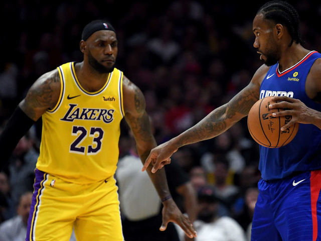 LOS ANGELES, CALIFORNIA - OCTOBER 22: Kawhi Leonard #2 of the LA Clippers controls possession of the ball in front of LeBron James #23 of the Los Angeles Lakers late in the fourth quarter in a 112-102 Clipper win during the LA Clippers season home opener at Staples Center on October 22, 2019 in Los Angeles, California.