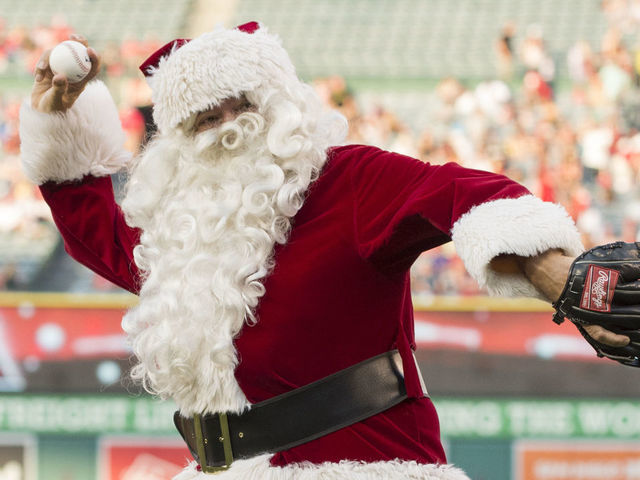 ANAHEIM, CA - JUNE 25: Santa Claus throws out a ceremonial first pitch as part of a "Christmas in June" promotion before the game between the Oakland Athletics and the Los Angeles Angels of Anaheim at Angel Stadium of Anaheim on June 25, 2016 in Anaheim, California.