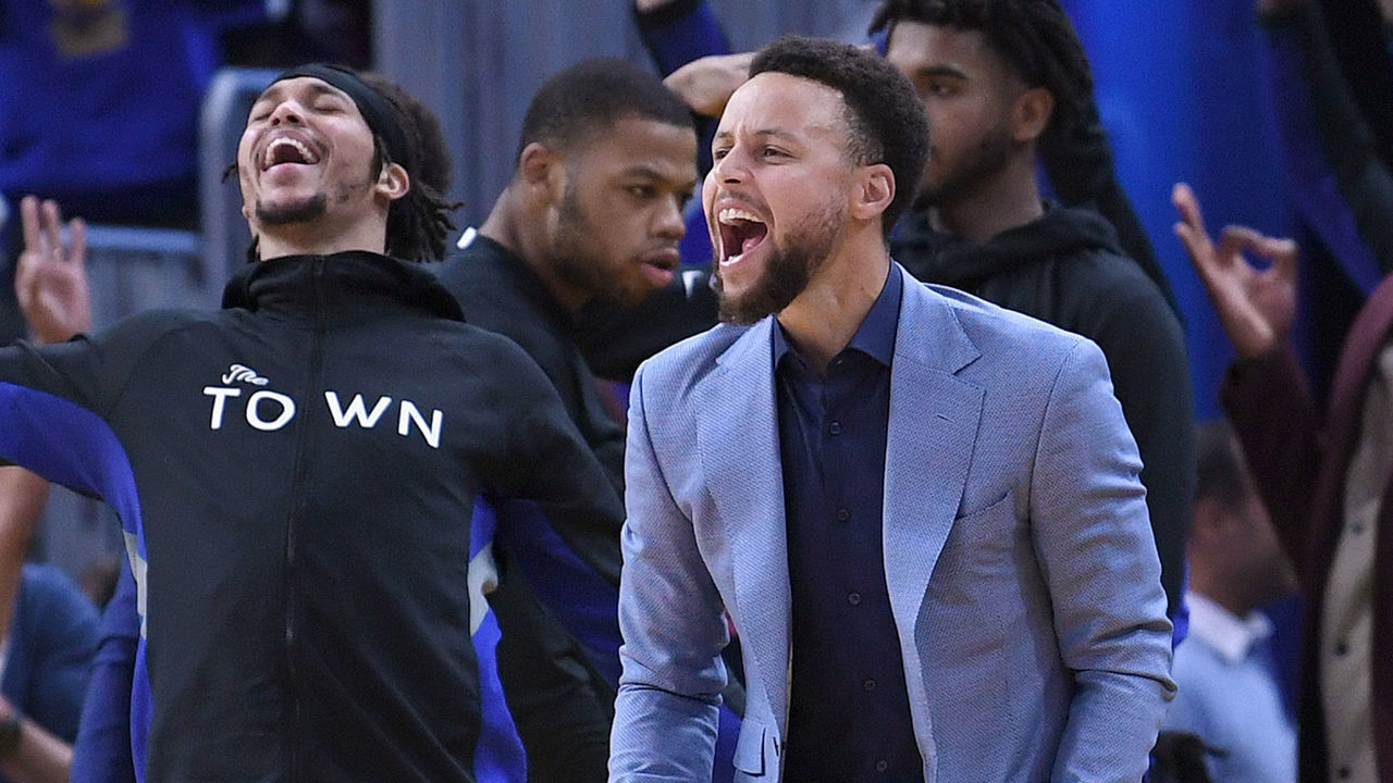 SAN FRANCISCO, CALIFORNIA - DECEMBER 25: Stephen Curry #30 of the Golden State Warriors celebrates off the bench after Draymond Green #23 made a three-point shot against the Houston Rockets during the second half of an NBA basketball game at Chase Center on December 25, 2019 in San Francisco, California.