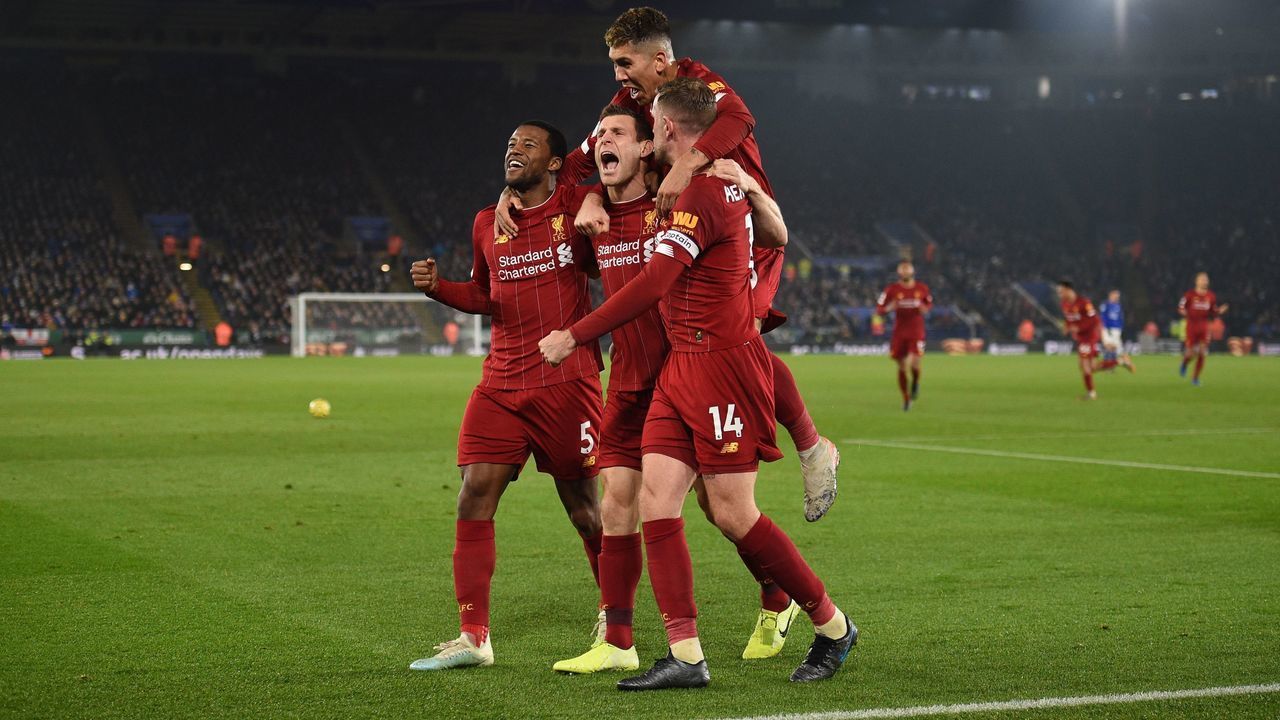 Liverpool's English midfielder James Milner (C) celebrates with teammates after scoring their second goal from the penalty spot during the English Premier League football match between Leicester City and Liverpool at King Power Stadium in Leicester, central England on December 26, 2019.