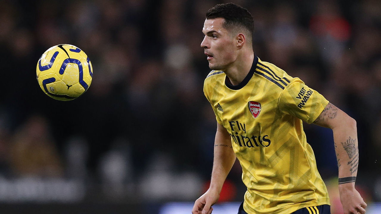 Arsenal's Swiss midfielder Granit Xhaka eyes the ball during the English Premier League football match between West Ham United and Arsenal at The London Stadium, in east London on December 9, 2019.