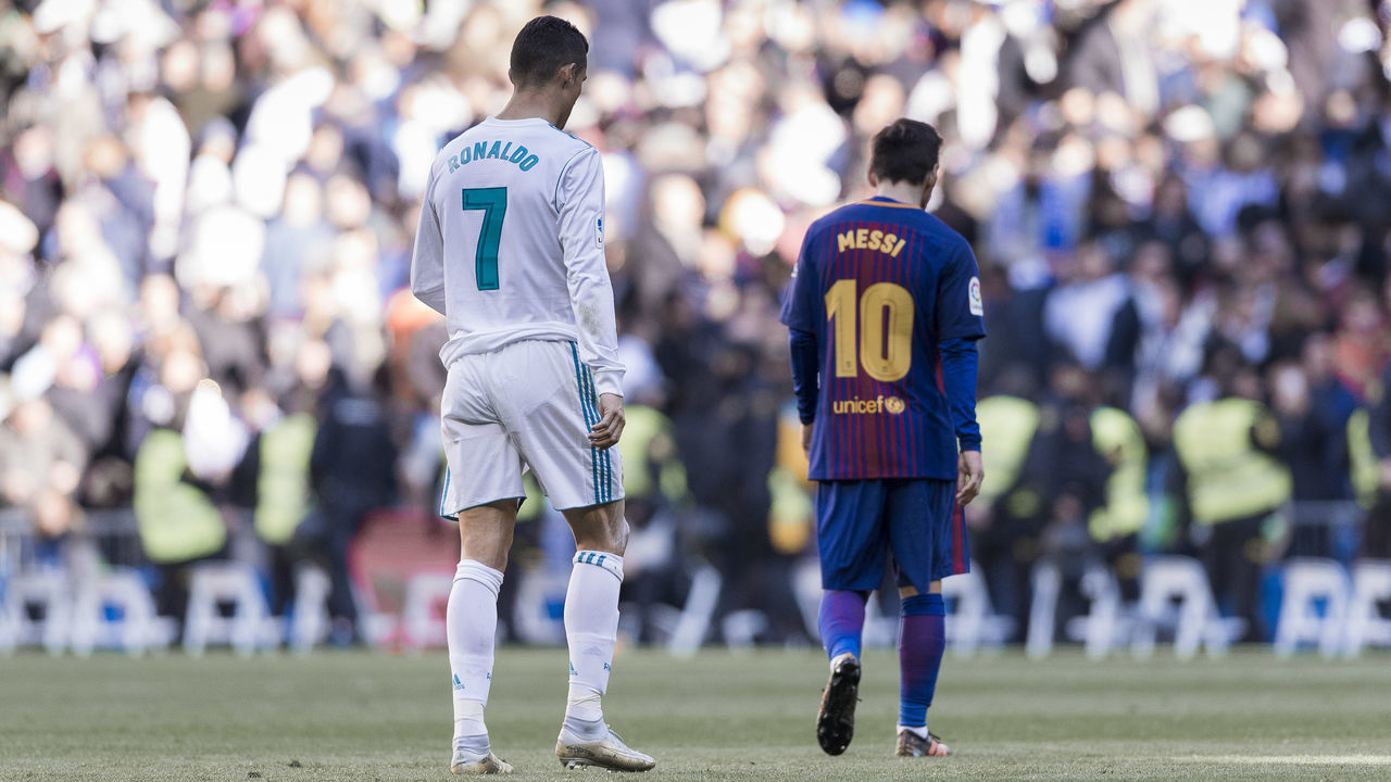 MADRID, SPAIN - DECEMBER 23: Lionel Messi of FC Barcelona and Cristiano Ronaldo of Real Madrid walk off pitch during La Liga match between Real Madrid and FC Barcelona at Santiago Bernabeu stadium on December 23, 2017 in Madrid, Spain.