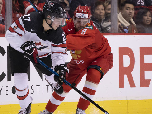 VANCOUVER, BC - DECEMBER 31: Saveli Olshanski #8 of Russia knocks Barrett Hayton #27 of Canada off the puck in Group A hockey action of the 2019 IIHF World Junior Championship on December, 31, 2018 at Rogers Arena in Vancouver, British Columbia, Canada.