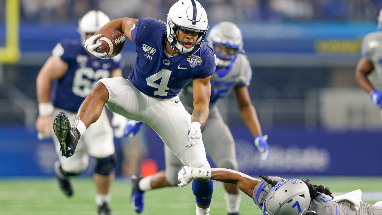 ARLINGTON, TX - DECEMBER 28: Penn State Nittany Lions running back Journey Brown (4) breaks through a tackle attempt by Memphis Tigers defensive back Chris Claybrooks (7) and scores a touchdown during the Cotton Bowl Classic between the Memphis Tigers and Penn State Nittany Lions on December 28, 2019 at AT&T Stadium in Arlington, TX.