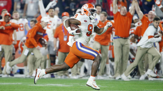 GLENDALE, ARIZONA - DECEMBER 28: Travis Etienne #9 of the Clemson Tigers carries the ball for a 53-yard touchdown reception against the Ohio State Buckeyes in the second half during the College Football Playoff Semifinal at the PlayStation Fiesta Bowl at State Farm Stadium on December 28, 2019 in Glendale, Arizona.