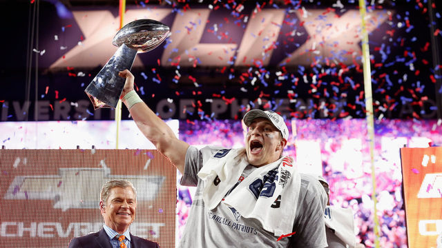 GLENDALE, AZ - FEBRUARY 01: Rob Gronkowski #87 of the New England Patriots celebrates with the Vince Lombardi Trophy after defeating the Seattle Seahawks 28-24 to win Super Bowl XLIX at University of Phoenix Stadium on February 1, 2015 in Glendale, Arizona.