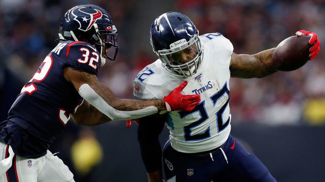 HOUSTON, TEXAS - DECEMBER 29: Derrick Henry #22 of the Tennessee Titans is pursued by Lonnie Johnson #32 of the Houston Texans during the first half at NRG Stadium on December 29, 2019 in Houston, Texas.