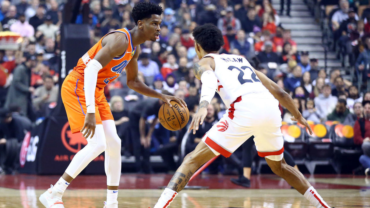 TORONTO, ON - DECEMBER 29: Shai Gilgeous-Alexander #2 of the Oklahoma City Thunder dribbles the ball as Patrick McCaw #22 of the Toronto Raptors defends during the first half of an NBA game at Scotiabank Arena on December 29, 2019 in Toronto, Canada.