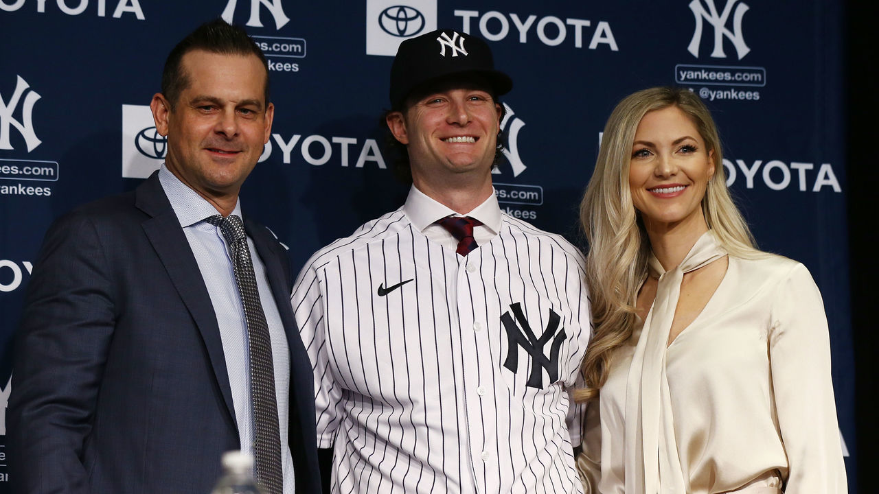NEW YORK, NEW YORK - DECEMBER 18: (L-R) Manager, Aaron Boone, Gerrit Cole and his wife Amy Cole pose for a photo at Yankee Stadium during a press conference at Yankee Stadium on December 18, 2019 in New York City.