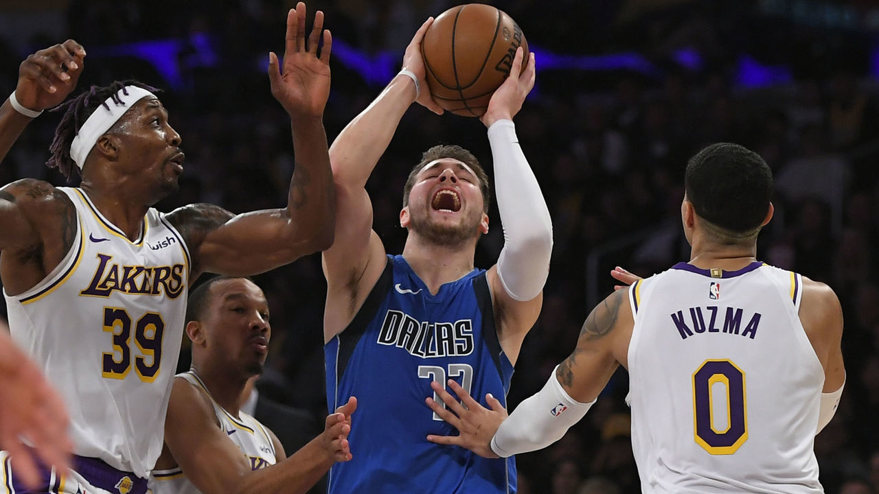 LOS ANGELES, CA - DECEMBER 29: Dwight Howard #39 of the Los Angeles Lakers fouls Luka Doncic #77 of the Dallas Mavericks while Kyle Kuzma #0 joins the play at Staples Center on December 29, 2019 in Los Angeles, California. NOTE TO USER: User expressly acknowledges and agrees that, by downloading and/or using this photograph, user is consenting to the terms and conditions of the Getty Images License Agreement.