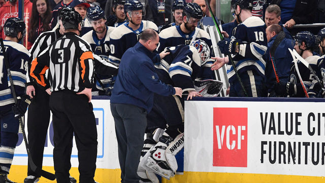 COLUMBUS, OH - DECEMBER 29: Goaltender Joonas Korpisalo #70 of the Columbus Blue Jackets is helped on to the bench by trainer Mike Vogt of the Columbus Blue Jackets after Korpisalo injured his right leg during a shoot out against the Chicago Blackhawks on December 29, 2019 at Nationwide Arena in Columbus, Ohio.