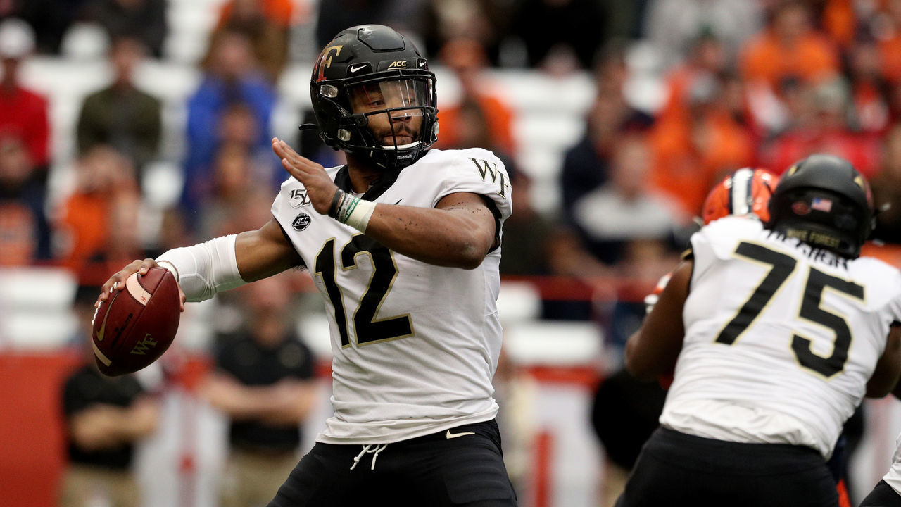 SYRACUSE, NEW YORK - NOVEMBER 30: Jamie Newman #12 of the Wake Forest Demon Deacons throws the ball during the first half of an NCAA football game against the Syracuse Orange at the Carrier Dome on November 30, 2019 in Syracuse, New York.