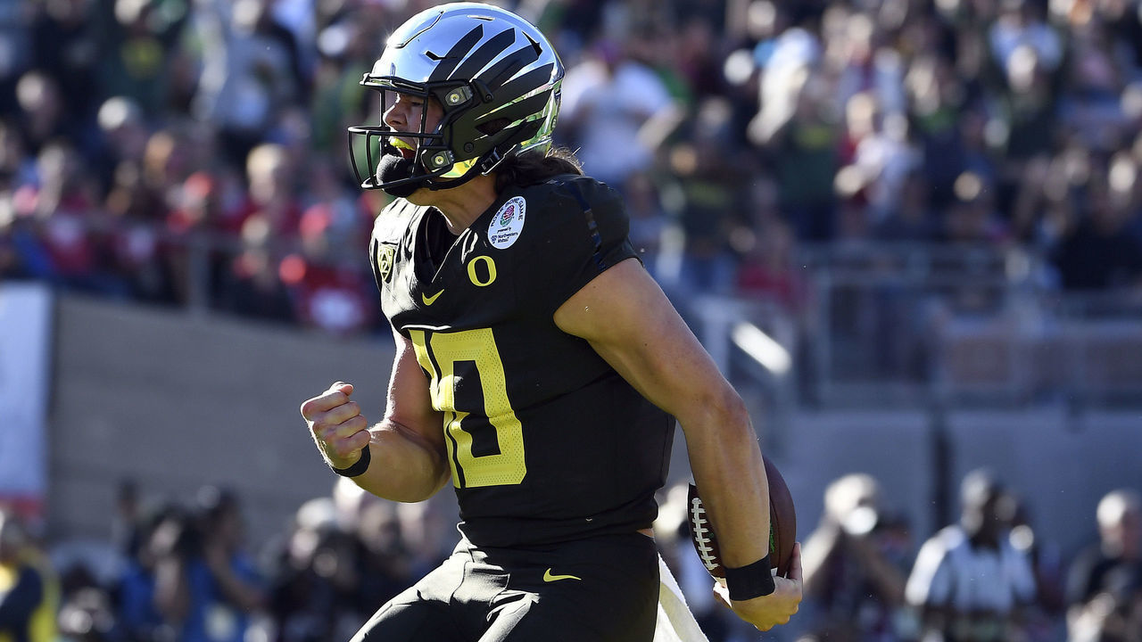 PASADENA, CALIFORNIA - JANUARY 01: Justin Herbert #10 of the Oregon Ducks celebrates after scoring a four yard touchdown against the Wisconsin Badgers during the first quarter in the Rose Bowl game presented by Northwestern Mutual at Rose Bowl on January 01, 2020 in Pasadena, California.