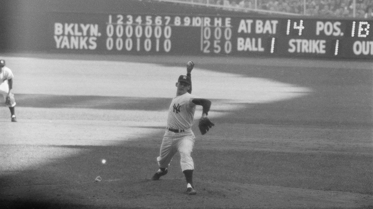 (Original Caption) The Writing on the Wall. New York: Yankee hurler Don Larsen studies the scoreboard at Yankee Stadium in the top of the 8th inning as he neared the feat of pitching the first perfect game in World Series history to give the Yankees a 2-0 victory over the Dodgers and a 3-to-2 game lead in the 1956 classic. The 27-year-old right hander threw only 97 pitches as he turned back 27 Dodgers in a row, seven of them on strikeouts. Larsen, who disdained any wind-up against the Dodgers, became the seventh man in all of baseball history to pitch a perfect game.