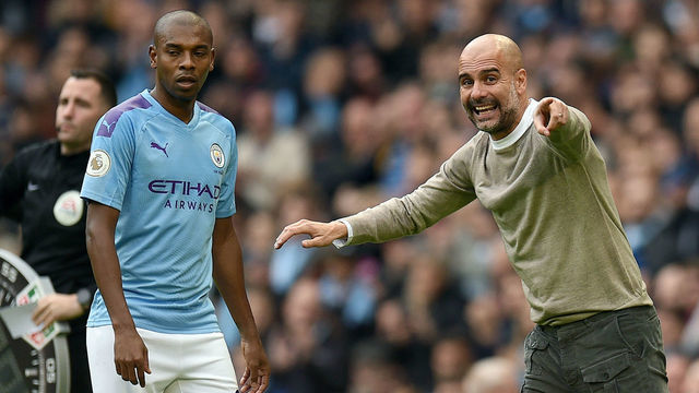 Manchester City's Spanish manager Pep Guardiola (R) gives instructions to Manchester City's Brazilian midfielder Fernandinho during the English Premier League football match between Manchester City and Wolverhampton Wanderers at the Etihad Stadium in Manchester, north west England, on October 6, 2019.