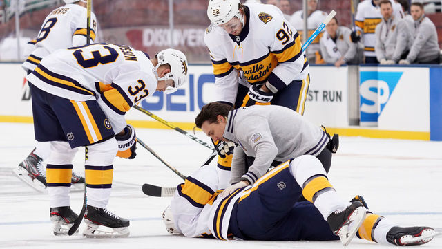 DALLAS, TEXAS - JANUARY 01: Ryan Ellis #4 of the Nashville Predators is is helped to his skates by his teammates and a team trainer after taking an elbow to the head from Corey Perry #10 of the Dallas Stars (not in photo) during first period of the 2020 NHL Winter Classic between the Nashville Predators and the Dallas Stars at Cotton Bowl on January 01, 2020 in Dallas, Texas.