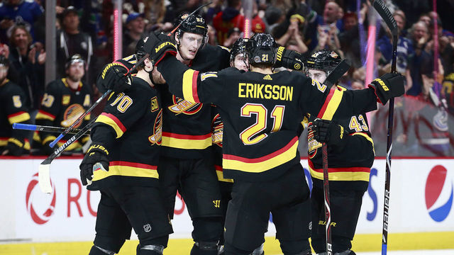 VANCOUVER, BC - JANUARY 4: Tyler Myers #57 of the Vancouver Canucks is congratulated by teammates Loui Eriksson #21, Tanner Pearson #70, Quinn Hughes #43, and Brock Boeser #6 after scoring during their NHL game against the New York Rangers at Rogers Arena January 4, 2020 in Vancouver, British Columbia, Canada.