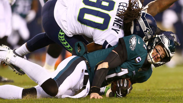 PHILADELPHIA, PENNSYLVANIA - JANUARY 05: Quarterback Carson Wentz #11 of the Philadelphia Eagles is hit by Jadeveon Clowney #90 of the Seattle Seahawks during the NFC Wild Card Playoff game at Lincoln Financial Field on January 05, 2020 in Philadelphia, Pennsylvania.