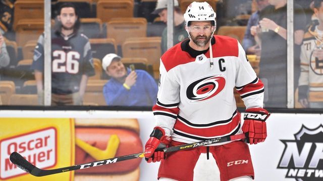 BOSTON, MA - MAY 09: Carolina Hurricanes right wing Justin Williams (14) passes the puck back and forth with a teammate in warm ups. During Game 1 of the Eastern Conference Finals featuring the Carolina Hurricanes against the Boston Bruins on May 09, 2019 at TD Garden in Boston, MA.