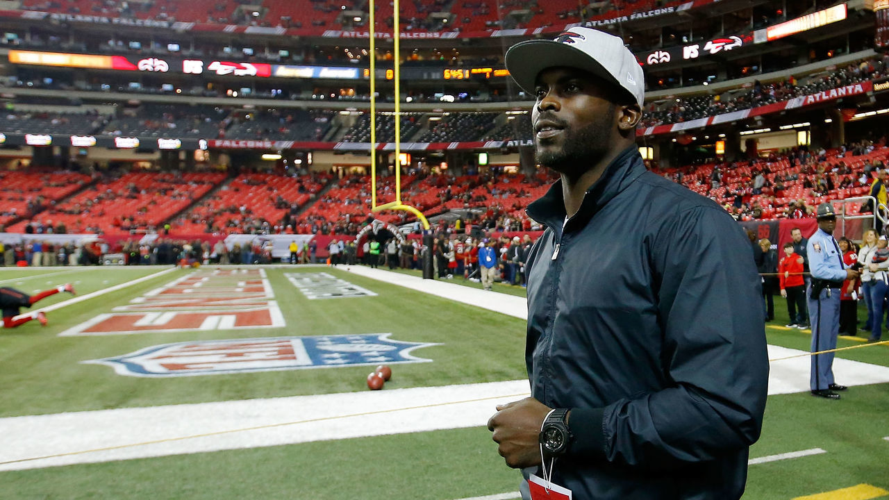 ATLANTA, GA - JANUARY 01: Former Atlanta Falcons player Michael Vick walks on the field prior to the game against the New Orleans Saints at the Georgia Dome on January 1, 2017 in Atlanta, Georgia.