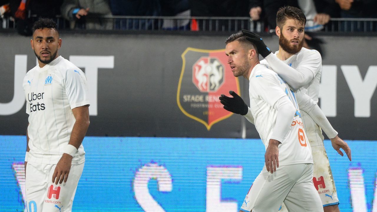 Marseille's Dutch midfielder Kevin Strootman (2ndR) is congratulated by Marseille's Croatian defender Duje Caleta Car (R) after scoring during the French L1 Football match between Stade Rennais Football Club and Olympique de Marseille, on January 10, 2020, at the Roazhon Park, in Rennes, western France.