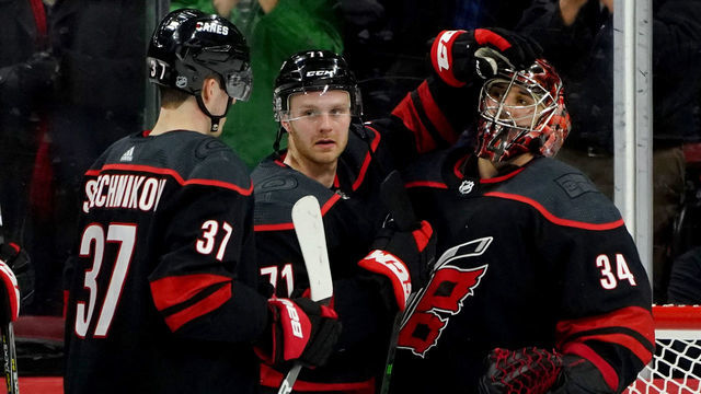 RALEIGH, NC - JANUARY 10: Petr Mrazek #34 of the Carolina Hurricanes is congratulated for a shutout win by teammate Lucas Wallmark #71 during an NHL game against the Arizona Coyotes on January 10, 2020 at PNC Arena in Raleigh, North Carolina.