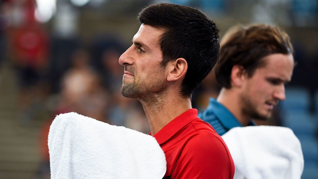 Novak Djokovic of Serbia (L) walks to his end in his men's singles match against Daniil Medvedev of Russia at the ATP Cup tennis tournament in Sydney on January 11, 2020.