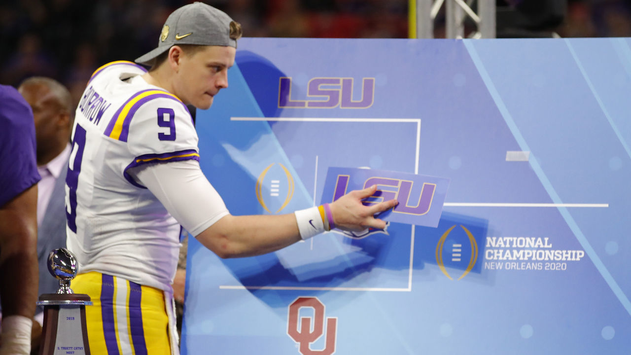 ATLANTA, GEORGIA - DECEMBER 28: Quarterback Joe Burrow #9 of the LSU Tigers post the "LSU" sticker on the oversized bracket to indicate advancing to the National Championship in New Orleans after winning the Chick-fil-A Peach Bowl 28-63 over the Oklahoma Sooners at Mercedes-Benz Stadium on December 28, 2019 in Atlanta, Georgia.