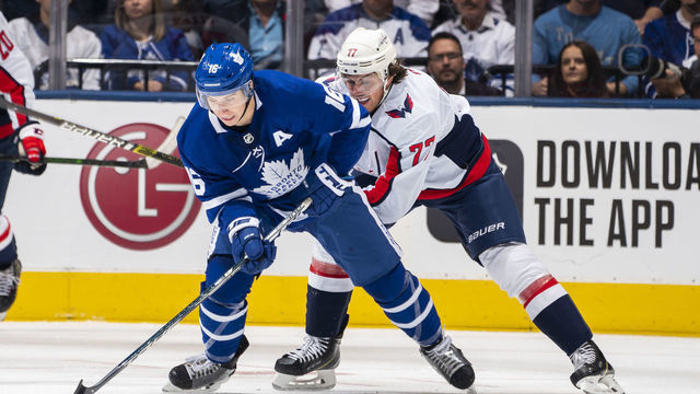 TORONTO, ON - OCTOBER 29: Mitch Marner #16 of the Toronto Maple Leafs plays the puck against T.J. Oshie #77 of the Washington Capitals during the first period at the Scotiabank Arena on October 29, 2019 in Toronto, Ontario, Canada.