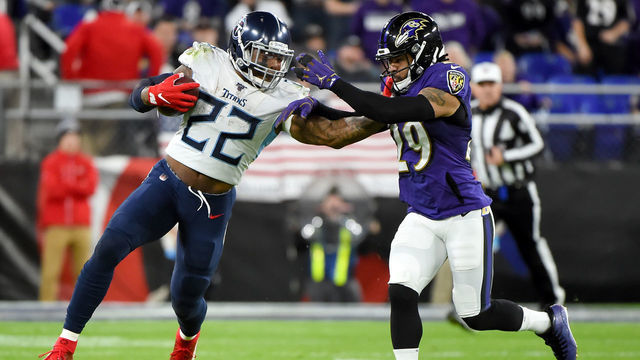 BALTIMORE, MARYLAND - JANUARY 11: Derrick Henry #22 of the Tennessee Titans carries the ball against Earl Thomas #29 of the Baltimore Ravens during the AFC Divisional Playoff game at M&T Bank Stadium on January 11, 2020 in Baltimore, Maryland.
