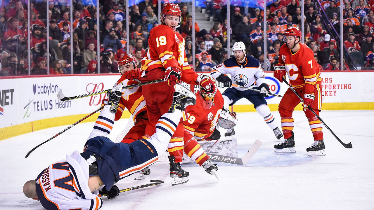 CALGARY, AB - JANUARY 11: Calgary Flames Right Wing Matthew Tkachuk (19) bodychecks Edmonton Oilers Right Wing Zack Kassian (44) to the ice during the first period of an NHL game where the Calgary Flames hosted the Edmonton Oilers on January 11, 2020, at the Scotiabank Saddledome in Calgary, AB.